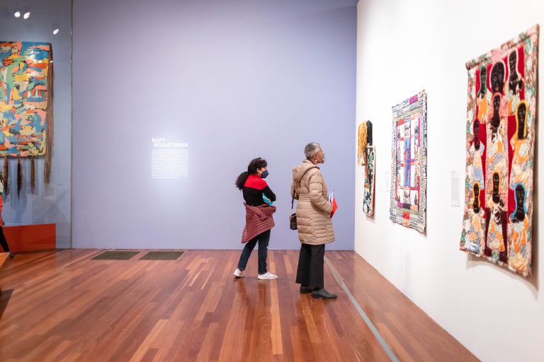 Viewing “Women's Liberation Talking Mask” (1973). American People in the galleries of the de Young Museum. Faith Ringgold Celebration at the de Young. Novemeber 22, 2022. Photo by Gary Sexton